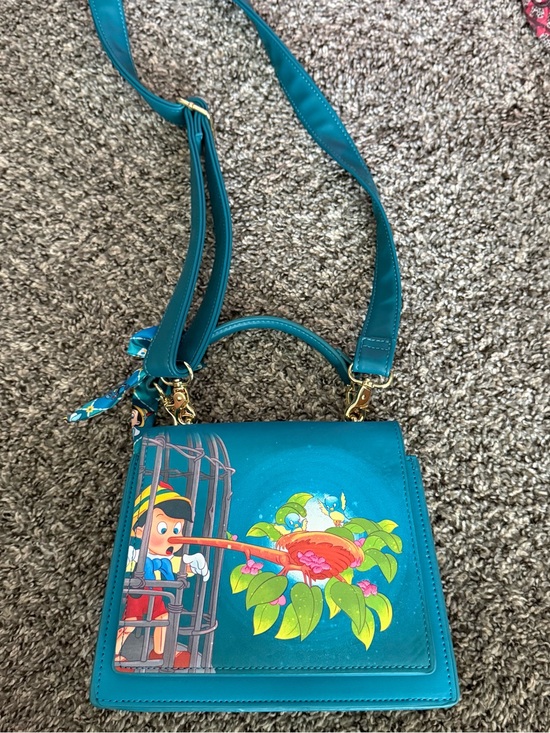 Loungefly Handbags - Loungefly Teal Pinocchio Illustration Crossbody Bag